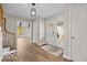 Bright foyer featuring hardwood floors, stylish light fixture, staircase and double glass doors that fill the space with natural light at 19041 Karyn Ln, Westfield, IN 46062