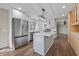 Open kitchen featuring stainless steel appliances, white cabinetry, and a large center island at 19041 Karyn Ln, Westfield, IN 46062