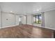Well-lit living room with hardwood floors and white wainscotting that features a large window and double doors at 19041 Karyn Ln, Westfield, IN 46062