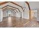 Expansive living room featuring hardwood floors, wood beam ceilings, and a mix of natural and artificial light sources at 19041 Karyn Ln, Westfield, IN 46062