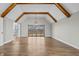 Inviting living room featuring hardwood floors, vaulted ceilings with wooden beams, and sliding glass doors leading to the deck at 19041 Karyn Ln, Westfield, IN 46062