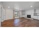 Open-concept living room with hardwood floors features a fireplace flanked by built-in cabinets, and a large window for natural light at 19041 Karyn Ln, Westfield, IN 46062