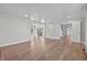 Spacious living room with hardwood floors and white beadboard ceiling, leading to kitchen and staircase at 19041 Karyn Ln, Westfield, IN 46062