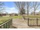 Backyard view from deck featuring a spacious yard with mature trees and a shed under a sunny sky at 204 Plainview Dr, Avon, IN 46123