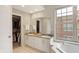 Bathroom featuring double sinks, granite countertops, and a walk-in closet at 226 N Cleveland St # 226E, Indianapolis, IN 46204