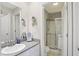Bathroom with a granite countertop sink, a vanity mirror, and a glass shower stall at 226 N Cleveland St # 226E, Indianapolis, IN 46204