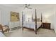 Bright bedroom featuring a four-poster bed, ceiling fan, and neutral decor at 226 N Cleveland St # 226E, Indianapolis, IN 46204