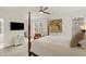 Spacious bedroom with a four-poster bed, mounted TV, and large windows at 226 N Cleveland St # 226E, Indianapolis, IN 46204