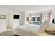Bedroom featuring a queen bed, large windows, and a comfortable sitting area at 226 N Cleveland St # 226E, Indianapolis, IN 46204