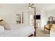 Bedroom with a four-poster bed, ceiling fan, and an open view to the ensuite bath at 226 N Cleveland St # 226E, Indianapolis, IN 46204