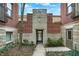 Apartment building entrance with brick and stone accents, featuring a courtyard access and greenery at 226 N Cleveland St # 226E, Indianapolis, IN 46204