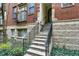 Apartment building front entrance featuring traditional brick facade and access staircase with iron railing at 226 N Cleveland St # 226E, Indianapolis, IN 46204