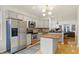 Well-lit kitchen featuring stainless steel appliances, light gray cabinets and an island with wood countertop at 226 N Cleveland St # 226E, Indianapolis, IN 46204