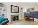 Cozy living room featuring a fireplace, built-in shelving, and hardwood floors at 226 N Cleveland St # 226E, Indianapolis, IN 46204