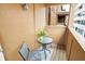 Small patio with a table and chairs overlooking the surrounding buildings at 226 N Cleveland St # 226E, Indianapolis, IN 46204