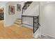 Modern staircase with hardwood floors, elegant railing, and stylish lighting that leads to the upper level at 226 N Cleveland St # 226E, Indianapolis, IN 46204