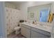 Bright bathroom features a double sink vanity with a large mirror and floral shower curtain at 2349 Dixon Creek Dr, Whitestown, IN 46075