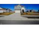 Attractive two-story home with gray siding, a white garage, and a well-manicured lawn on a sunny day at 2349 Dixon Creek Dr, Whitestown, IN 46075