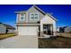 Charming two-story home with gray siding, white trim, and a two-car garage under a clear blue sky at 2349 Dixon Creek Dr, Whitestown, IN 46075