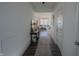 Bright hallway with wood floors leading to a cozy living room with plenty of natural light at 2349 Dixon Creek Dr, Whitestown, IN 46075