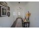 Well-lit hallway with elegant decor and wood floors, creating a welcoming entrance to the home at 2349 Dixon Creek Dr, Whitestown, IN 46075