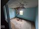 Renovation-ready bedroom with peeling paint, ceiling damage, and a sun-filled window, awaiting restoration at 2420 N Macedonia Ave, Muncie, IN 47303