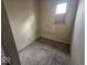 Small empty bedroom with drab flooring and a single window, ready for renovation and decor at 2420 N Macedonia Ave, Muncie, IN 47303