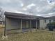 Single-story home featuring a covered porch and neutral siding, set within a residential area at 2420 N Macedonia Ave, Muncie, IN 47303