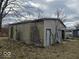 Exterior shot of a detached garage with weathered siding and a sliding door at 2420 N Macedonia Ave, Muncie, IN 47303