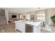 Open-concept kitchen with stainless steel appliances, a large island, and seamless flow to the dining and living areas at 250 Evening Bay Ct, Pendleton, IN 46064