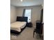 Bedroom featuring a bed, a nightstand with a lamp, dresser, chair, and a window at 2536 Lanai Ln, Greenwood, IN 46143