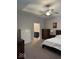 Bedroom featuring a bed, ceiling fan, two dressers, nightstand with lamp, and bathroom view at 2536 Lanai Ln, Greenwood, IN 46143