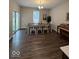 Dining room with a table, chairs, piano, chandelier and patio door at 2536 Lanai Ln, Greenwood, IN 46143