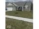 Side view of a charming home showcasing a well-kept lawn, landscaping, and complementary brick and siding at 2536 Lanai Ln, Greenwood, IN 46143
