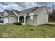 Side view of a charming home showcasing a well-kept lawn, landscaping, and complementary brick and siding at 2536 Lanai Ln, Greenwood, IN 46143