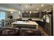The kitchen has dark wood cabinetry, stainless steel appliances, and an island with seating at 2536 Lanai Ln, Greenwood, IN 46143