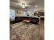 The living room has a large area rug and an open floor plan to the kitchen at 2536 Lanai Ln, Greenwood, IN 46143