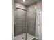 Modern tiled shower with glass door and neutral tones at 2536 Lanai Ln, Greenwood, IN 46143