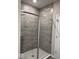 Modern tiled shower with glass door and neutral tones at 2536 Lanai Ln, Greenwood, IN 46143