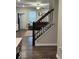 View of staircase with wood banister, with living room in the background at 2536 Lanai Ln, Greenwood, IN 46143
