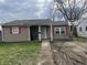 Exterior view of a single-story home featuring red shutters and a basketball hoop at 2813 Baltimore Ave, Indianapolis, IN 46218