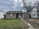 Cozy home with neutral siding, red shutters, and a small front yard at 2813 Baltimore Ave, Indianapolis, IN 46218
