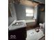 Bathroom featuring a sink, bathtub and toilet, all showing signs of disrepair at 312 N Grafton Ave, Muncie, IN 47303