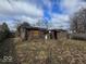 Exterior view of two rustic sheds surrounded by a dry, unkempt yard at 312 N Grafton Ave, Muncie, IN 47303