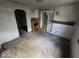A glimpse of the living room showing worn flooring and a vintage mantle at 312 N Grafton Ave, Muncie, IN 47303