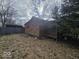Side view of a wooden shed showing its weathered exterior and surrounding yard at 312 N Grafton Ave, Muncie, IN 47303