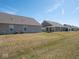 View of backyard area with grass, home exterior and utilities at 3252 Jasper Ln, Brownsburg, IN 46112