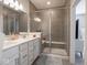 Bathroom showcasing a spacious glass-enclosed shower and a double sink vanity with quartz countertop at 3252 Jasper Ln, Brownsburg, IN 46112