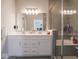 Bright bathroom features a double sink vanity with ample storage and a glass-enclosed shower at 3252 Jasper Ln, Brownsburg, IN 46112