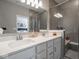 Well-lit bathroom with a double sink vanity, quartz countertop, and a modern glass-enclosed shower at 3252 Jasper Ln, Brownsburg, IN 46112